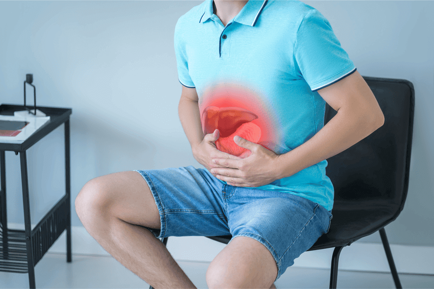 man holding stomach with hernia pain